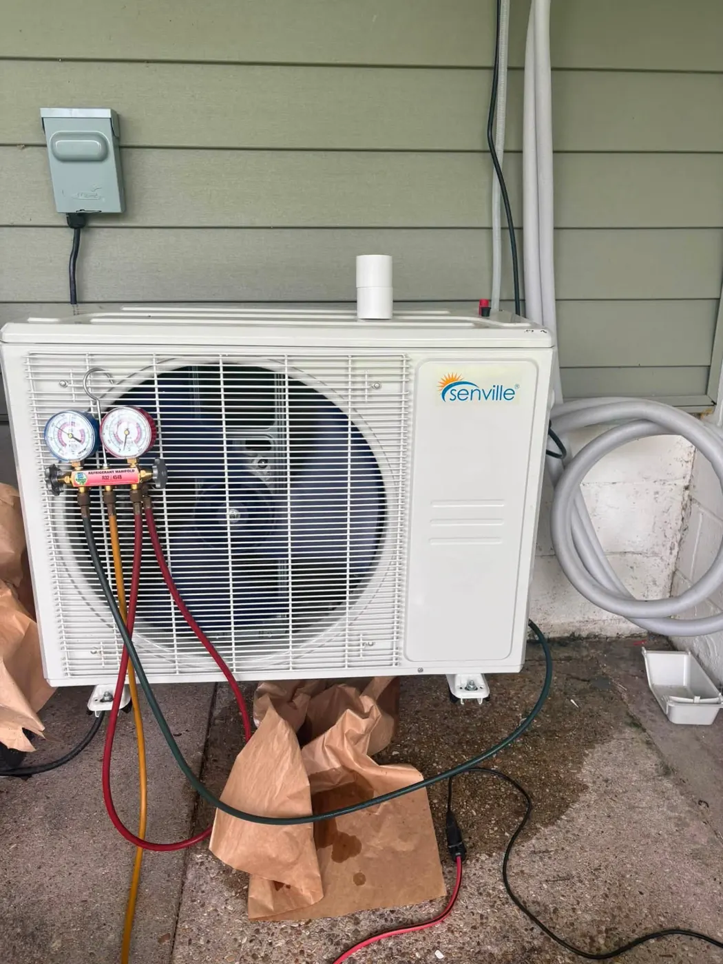 Mini-split outdoor condenser being serviced with gauges in Houma Louisiana